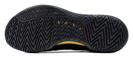 Black basketball shoe outsole with zigzag traction tread and yellow midsole stripe