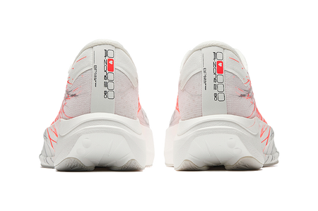 White running shoes with red accents on the heel, cushioned light gray sole