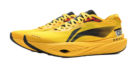 Yellow low-top running shoe, front side view, black stripe and red logo detail.