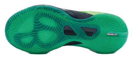 Green basketball shoe outsole with textured traction pattern and dark grip pods