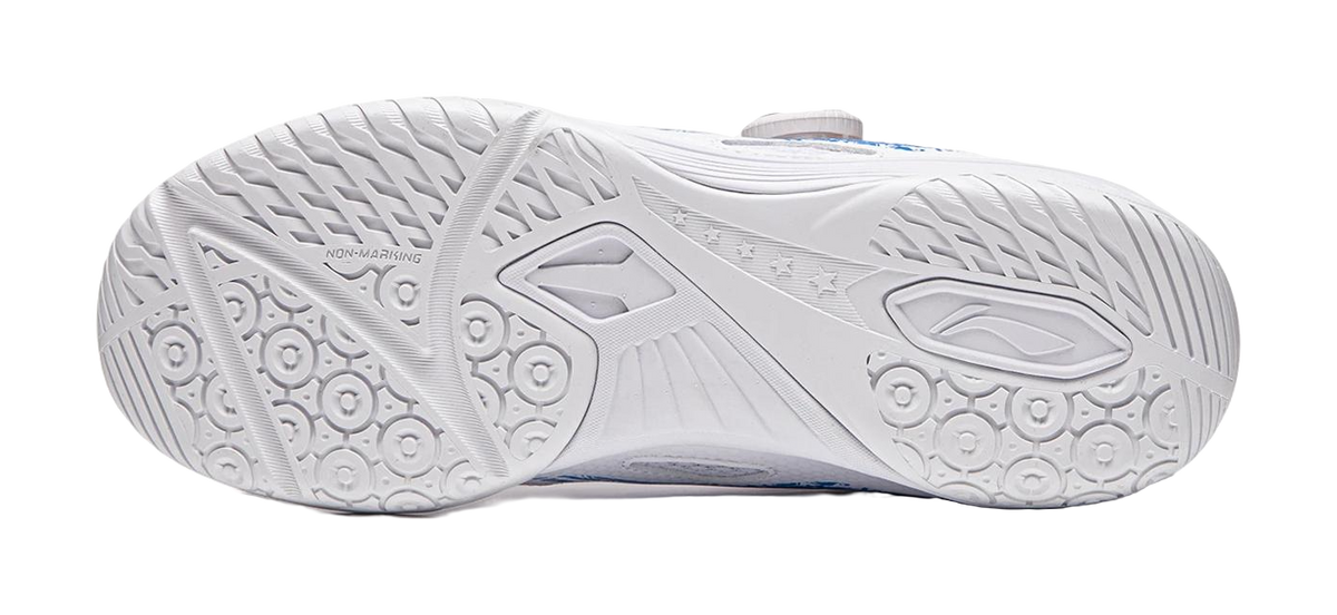 White table tennis shoe outsole with circular grip nodes and angular tread patterns.
