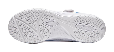 White table tennis shoe outsole with circular grip nodes and angular tread patterns.