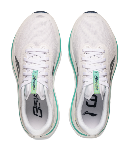 Pair of white lace-up running shoes front view with green-trim details and logos