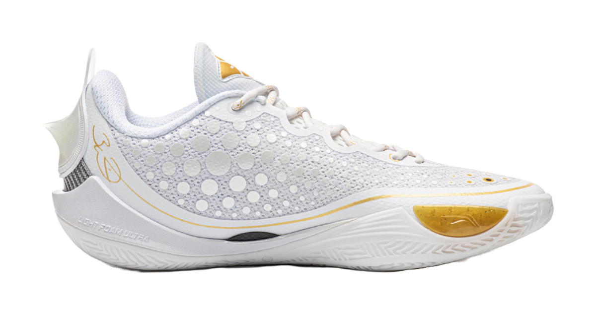 Low basketball shoe side view, perforated knit upper with gold-toe trim and white laces