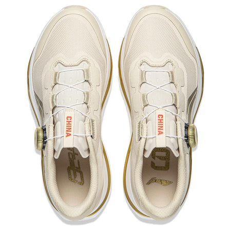 Pair of light beige running shoes shown from above with lace panels and gold accents.