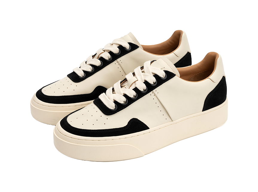 Low-top skate shoes, pair view, off-white canvas with black toe and side panels, laces.