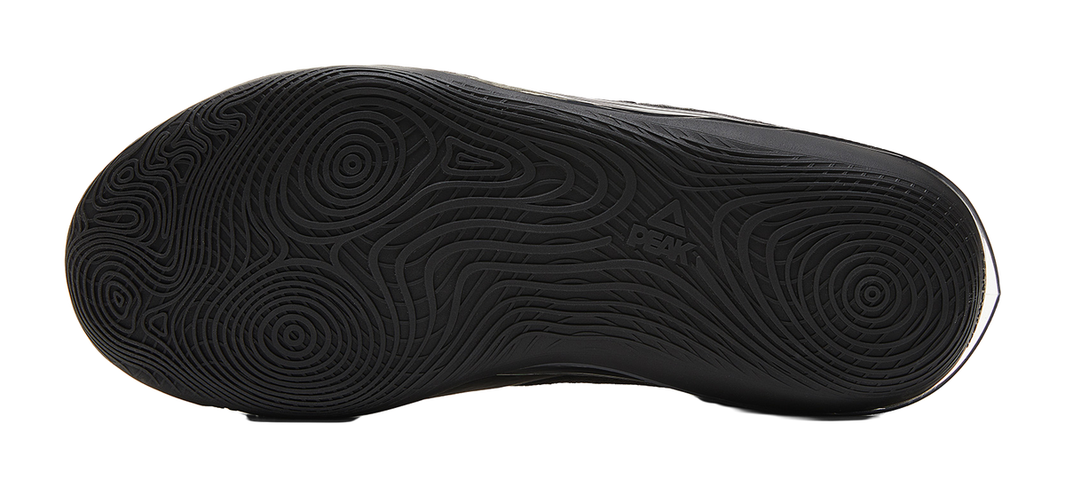 Black rubber basketball outsole with circular traction pattern
