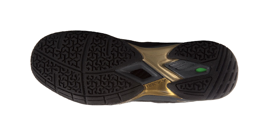 Unisex badminton shoe outsole, textured tread with gold center and green insert