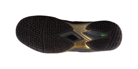 Unisex badminton shoe outsole, textured tread with gold center and green insert