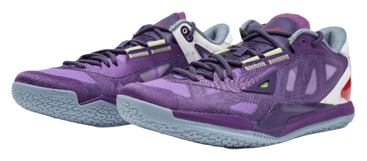Purple lace-up basketball shoes with camo-like pattern, white heel, and red side cutout