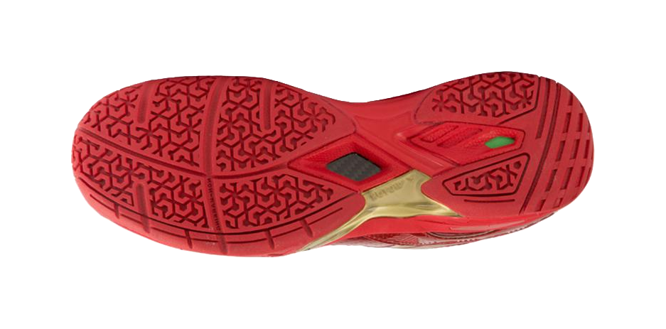 Red badminton shoe outsole with patterned tread and gold trim