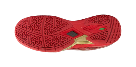 Red badminton shoe outsole with patterned tread and gold trim