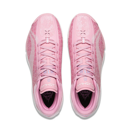 Pair of pink basketball shoes with lace-up tongues and black-lined interior