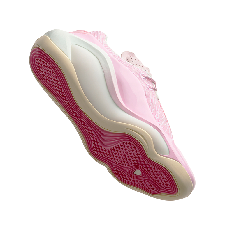 Men's bubble gum pink basketball shoe with red traction outsole, side view