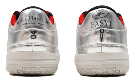 Silver basketball shoes heel view with red collar accents and thick tread sole