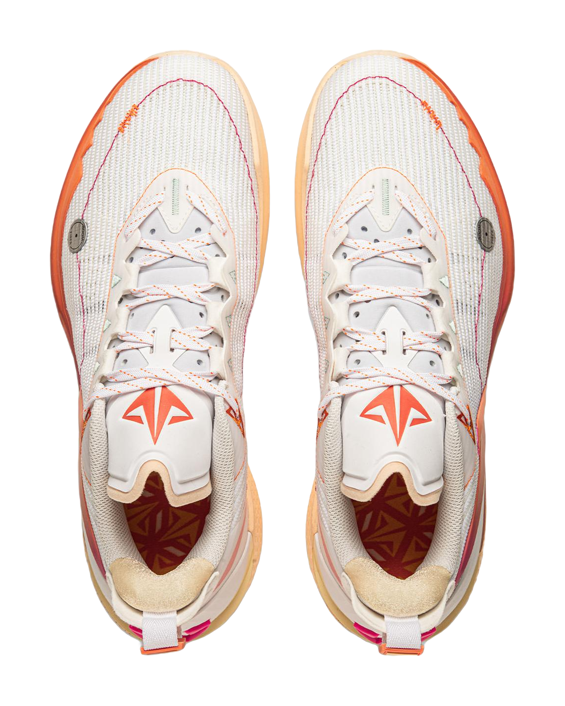 Pair of white basketball shoes with orange laces, magenta tongue detail