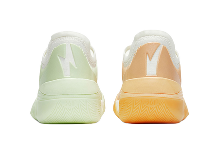 Pair of low basketball shoes: mint green left shoe, orange heel and sole on right