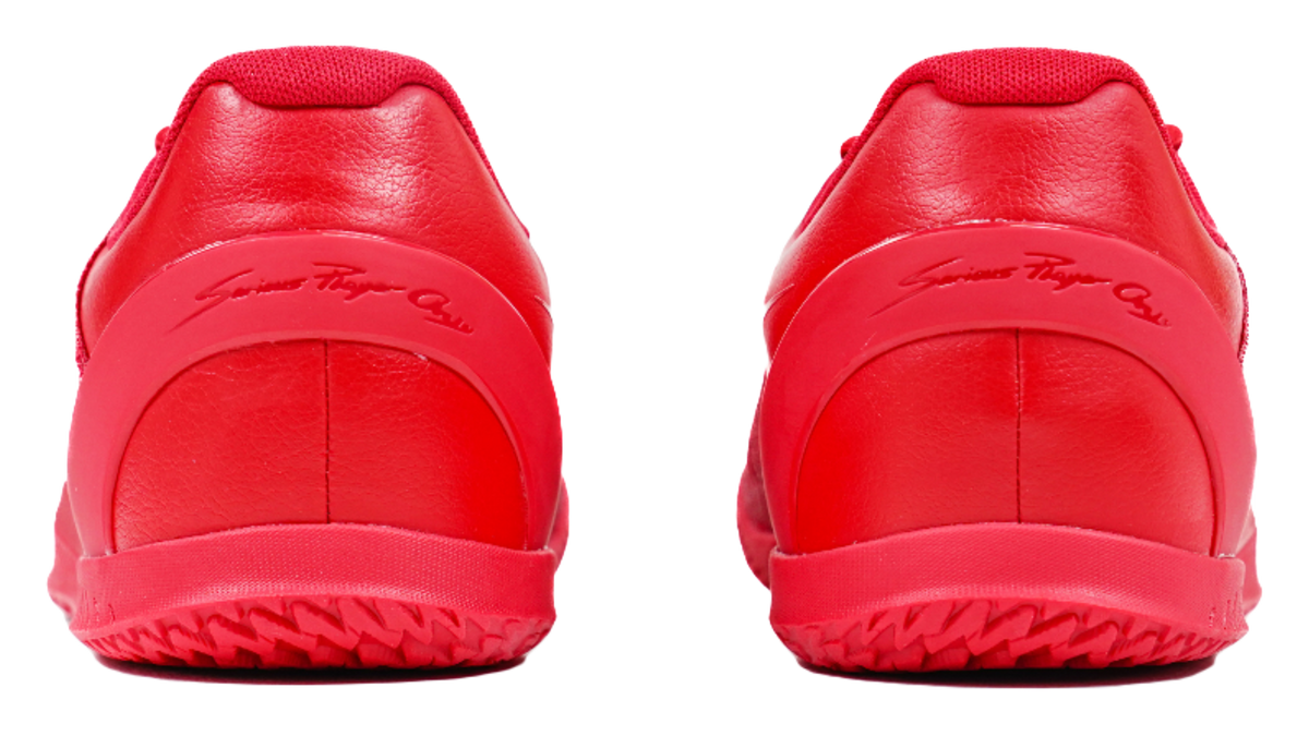 Red basketball shoes with smooth leather-like heel panels and rubber heel outsole