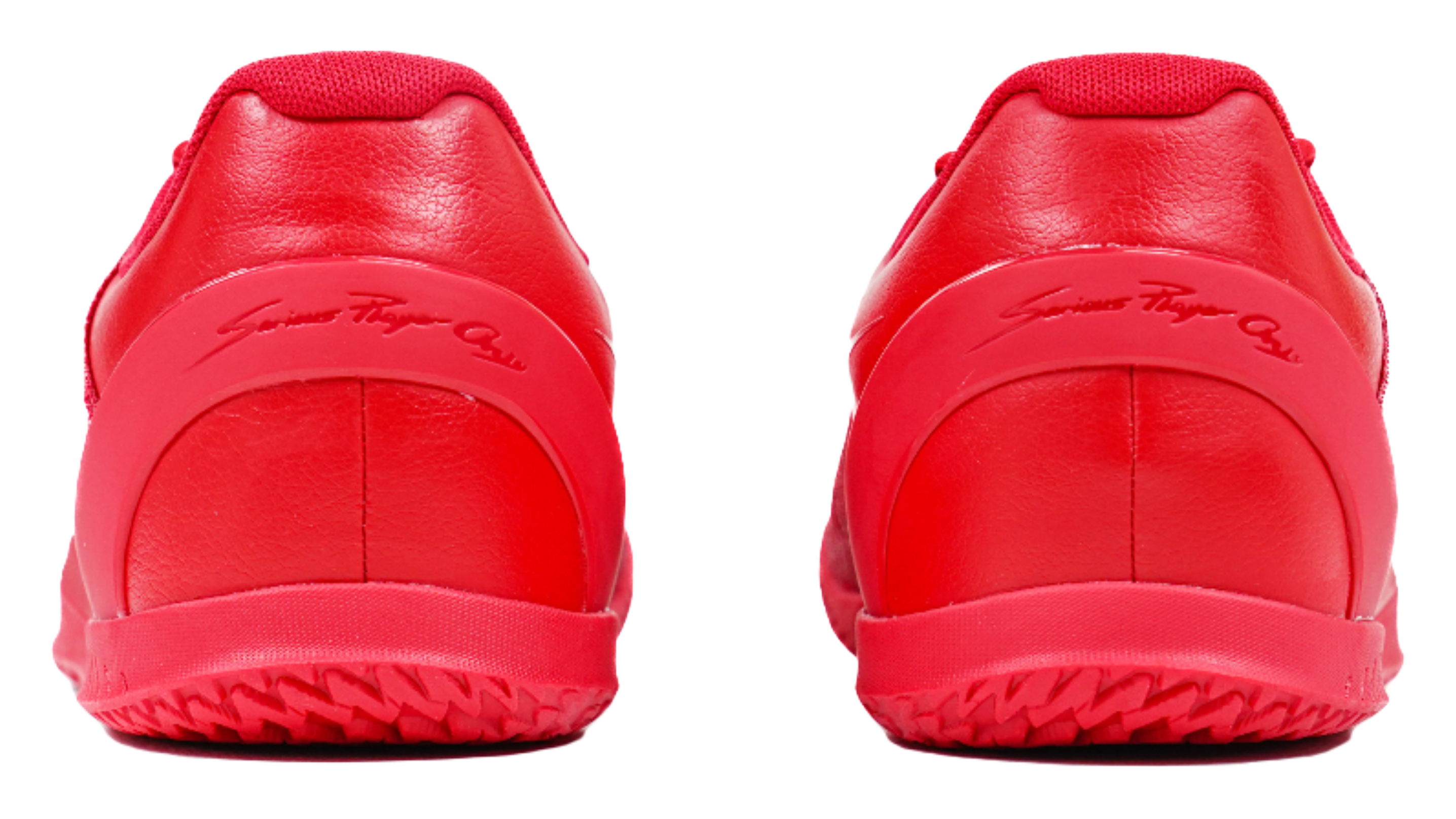 Red basketball shoes with smooth leather-like heel panels and rubber heel outsole