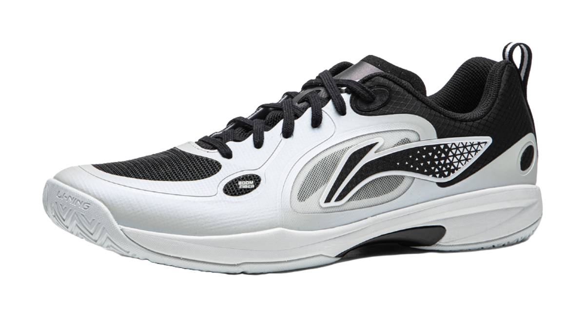 Table tennis shoe with black and gray upper panels, white laces, and side logo