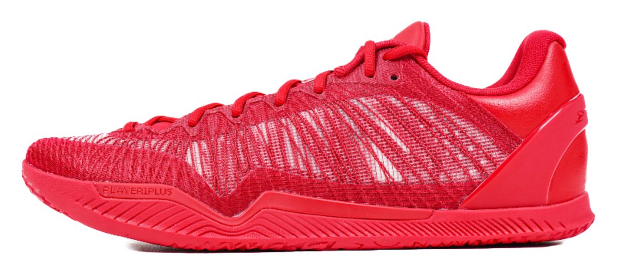 Red basketball shoe with knit upper, lace-up front, and red rubber outsole
