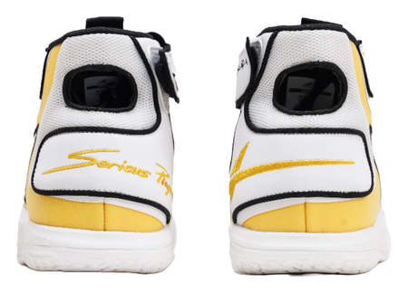 High-top basketball shoe heel view, white with yellow stripe and black collar trim