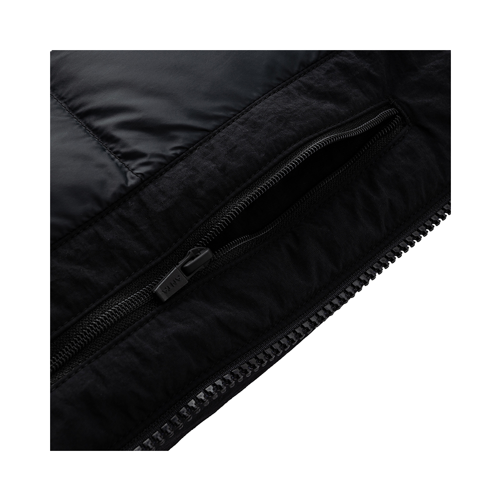 Black jacket close-up of centered zipper with black zipper pull.