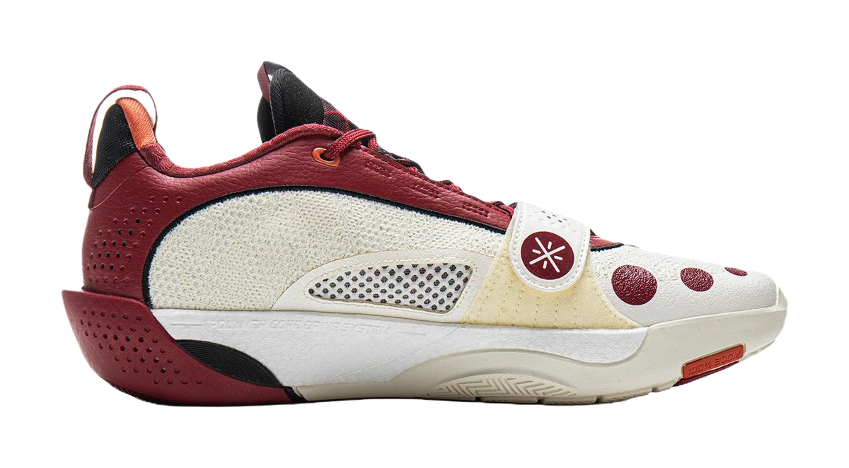 Red and white basketball shoe with mesh side panels, lace-up front, and low sole