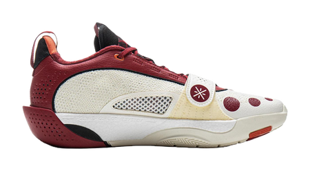 Red and white basketball shoe with mesh side panels, lace-up front, and low sole