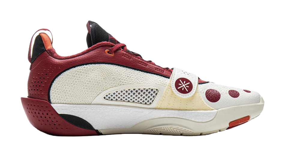 Red and white basketball shoe with mesh side panels, lace-up front, and low sole