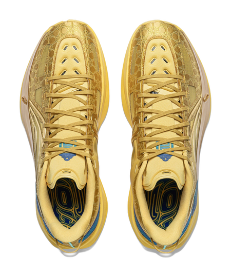 Pair of bright gold low-top sneakers with blue lining and lace-up front view