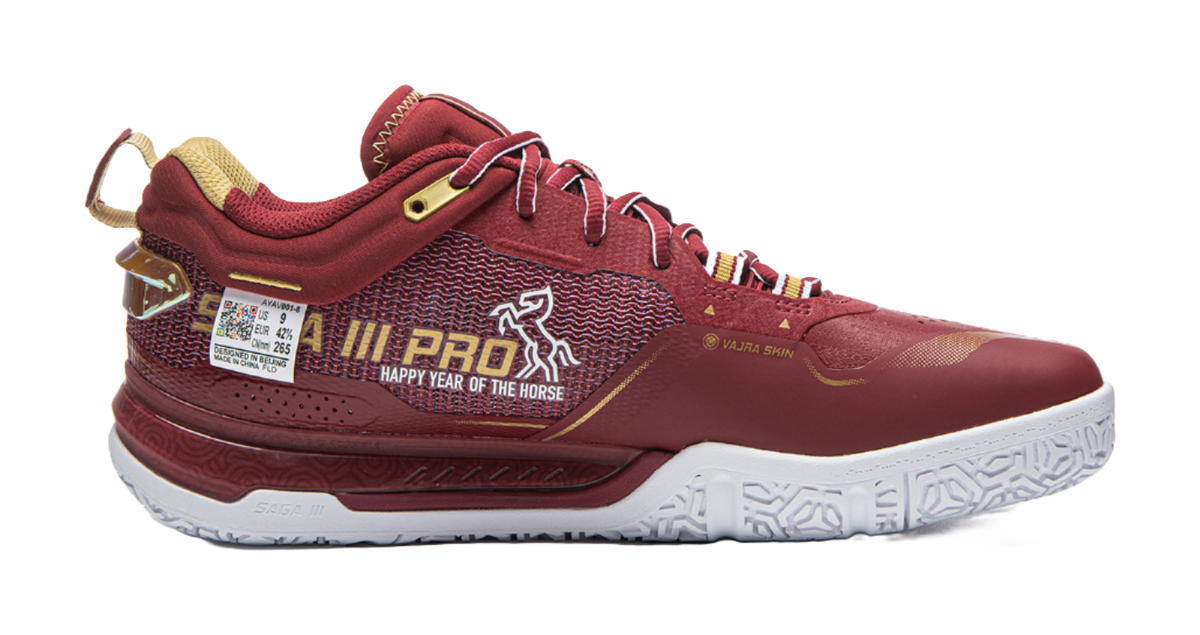 Red badminton shoe side view with patterned knit upper, white sole, and lace-up closure.