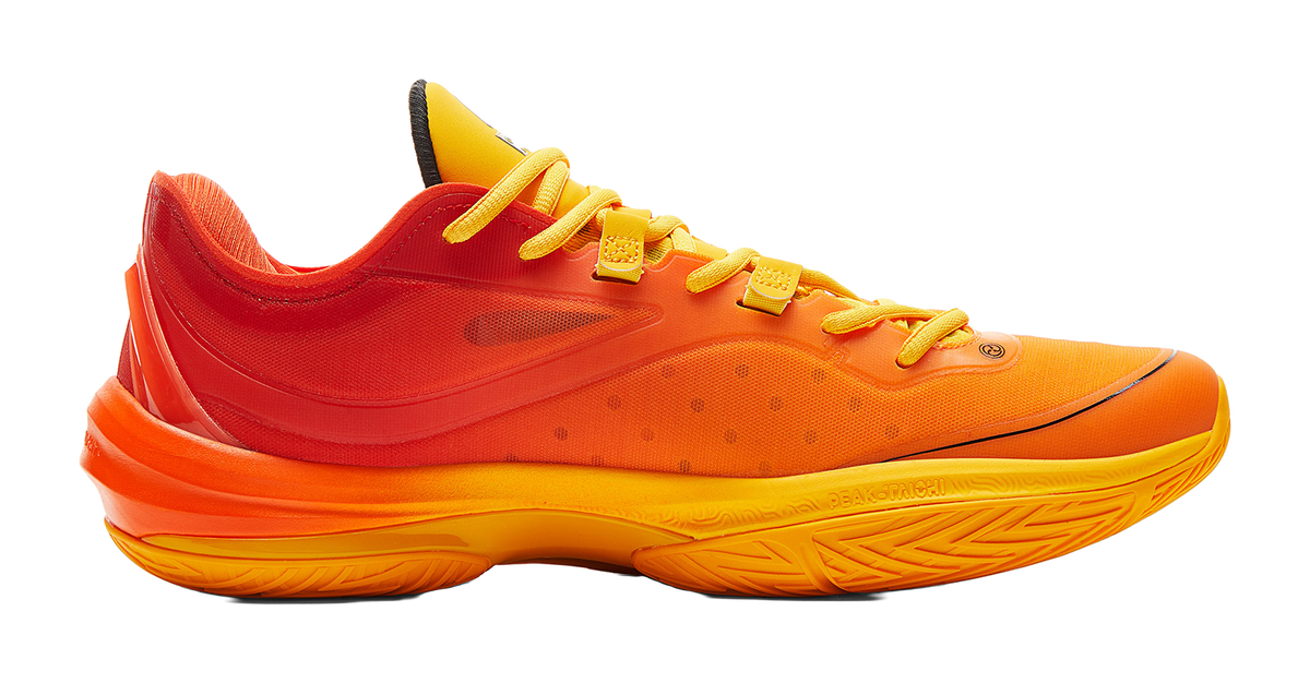 Basketball shoe side view with orange and yellow knit upper and thick cushioned sole