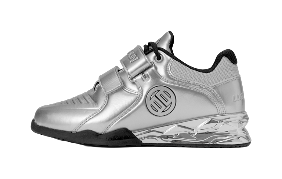 Silver metallic low-top training shoes with hook-and-loop strap and black accents