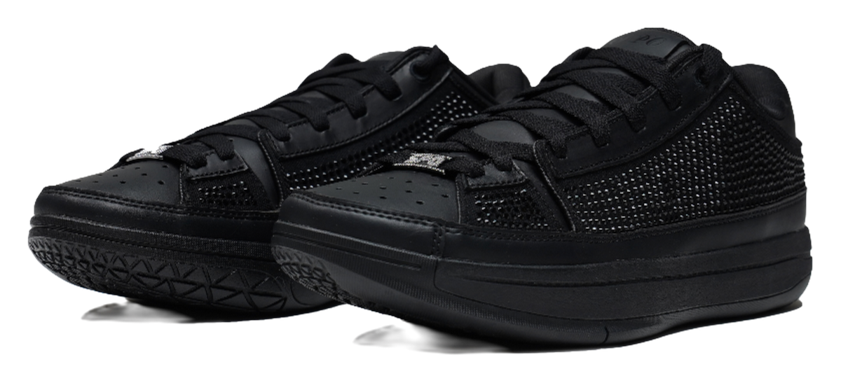Black lace-up basketball shoes with textured upper and thick rubber sole, angled view.