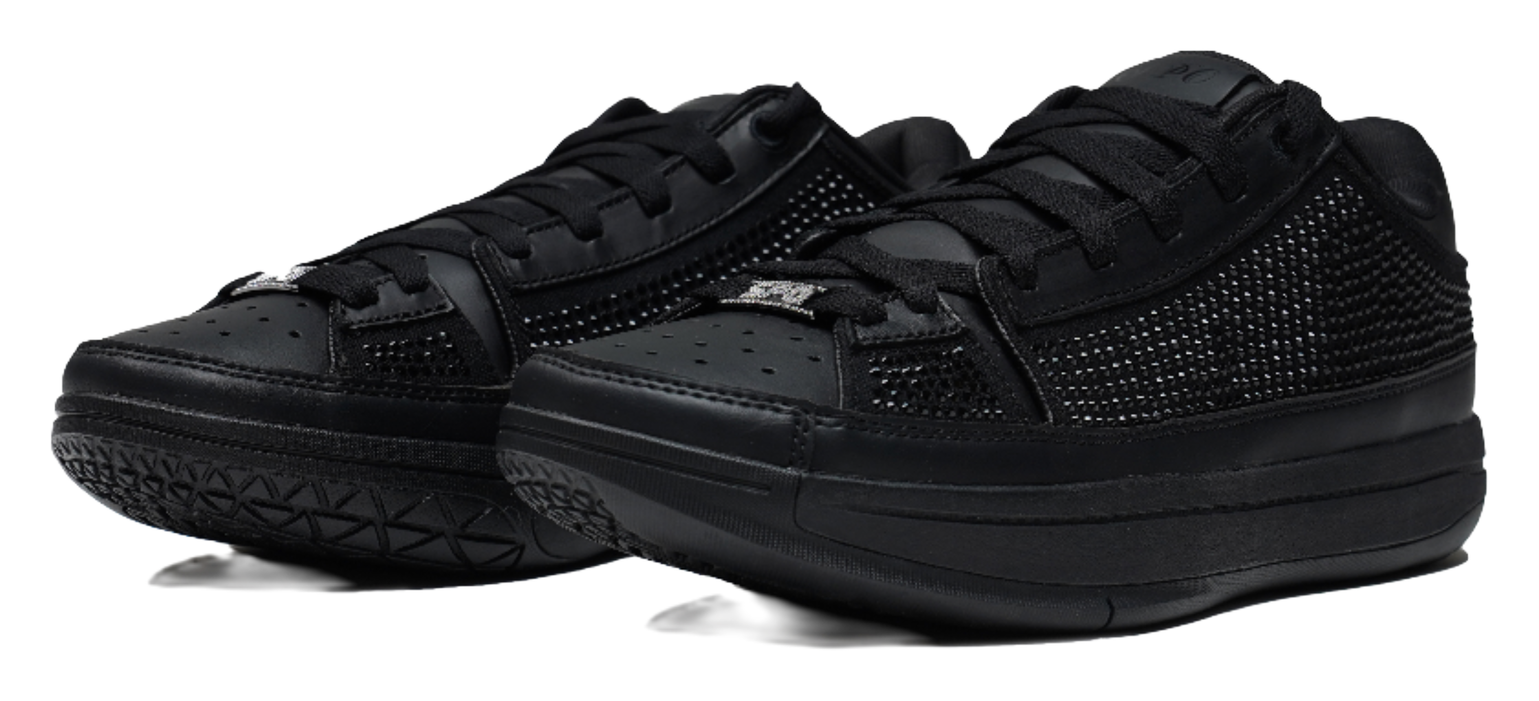 Black lace-up basketball shoes with textured upper and thick rubber sole, angled view.