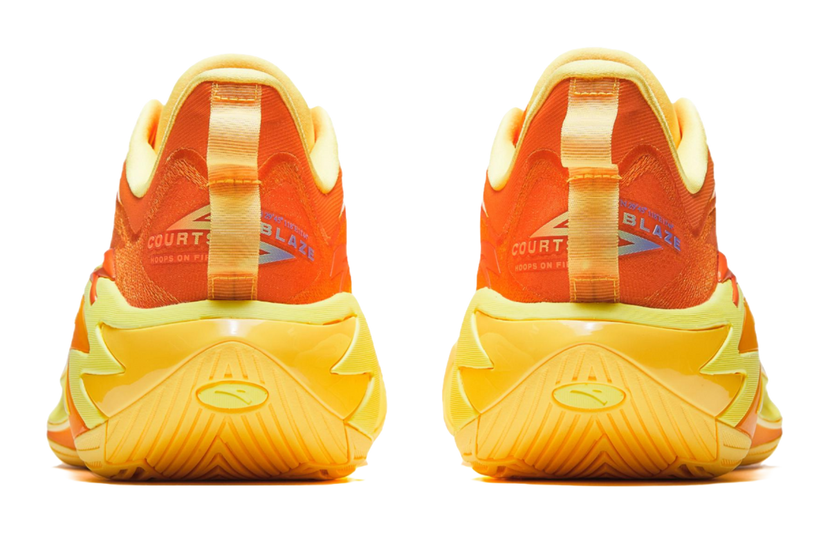 Basketball shoe heel view in yellow with orange collar, cushioned heel and traction details.