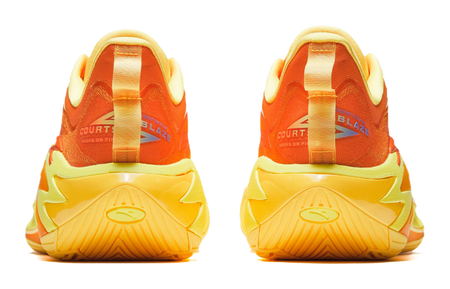 Basketball shoe heel view in yellow with orange collar, cushioned heel and traction details.