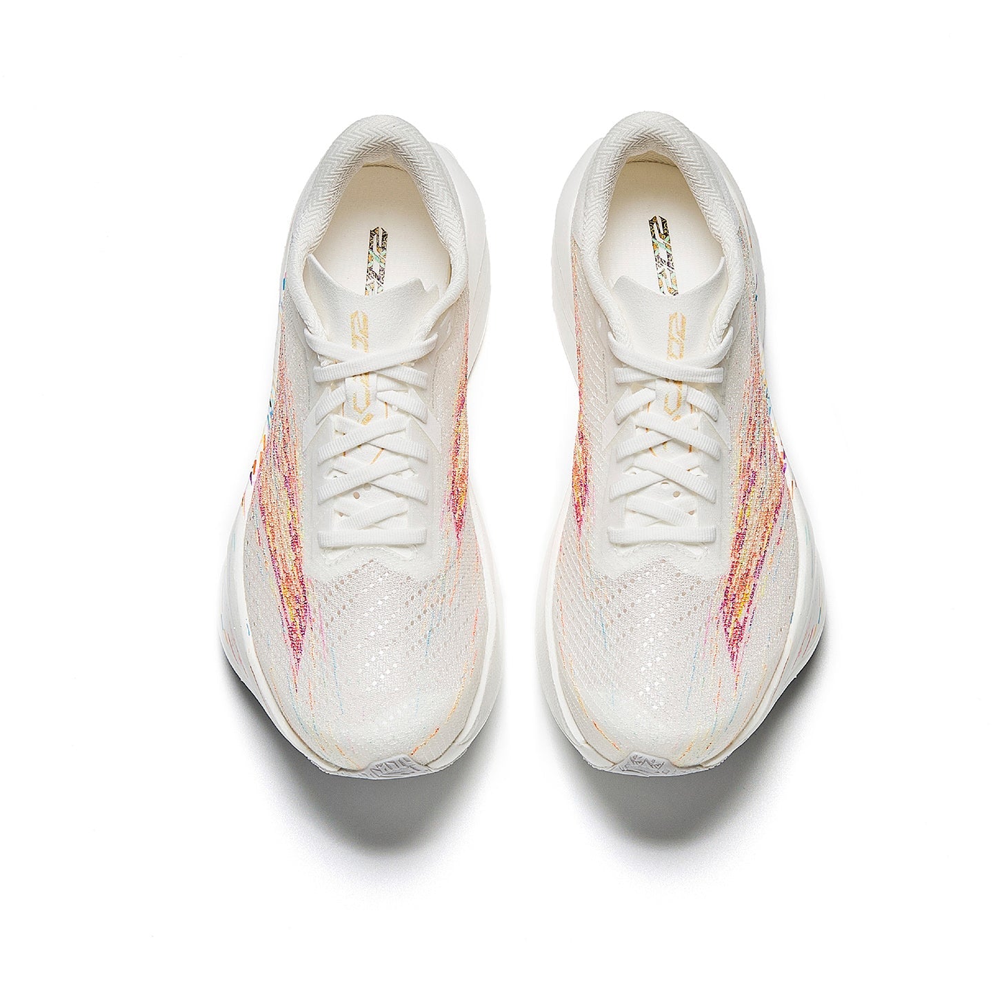 Women's running shoes, front view with white laces and multicolor paint-splatter upper