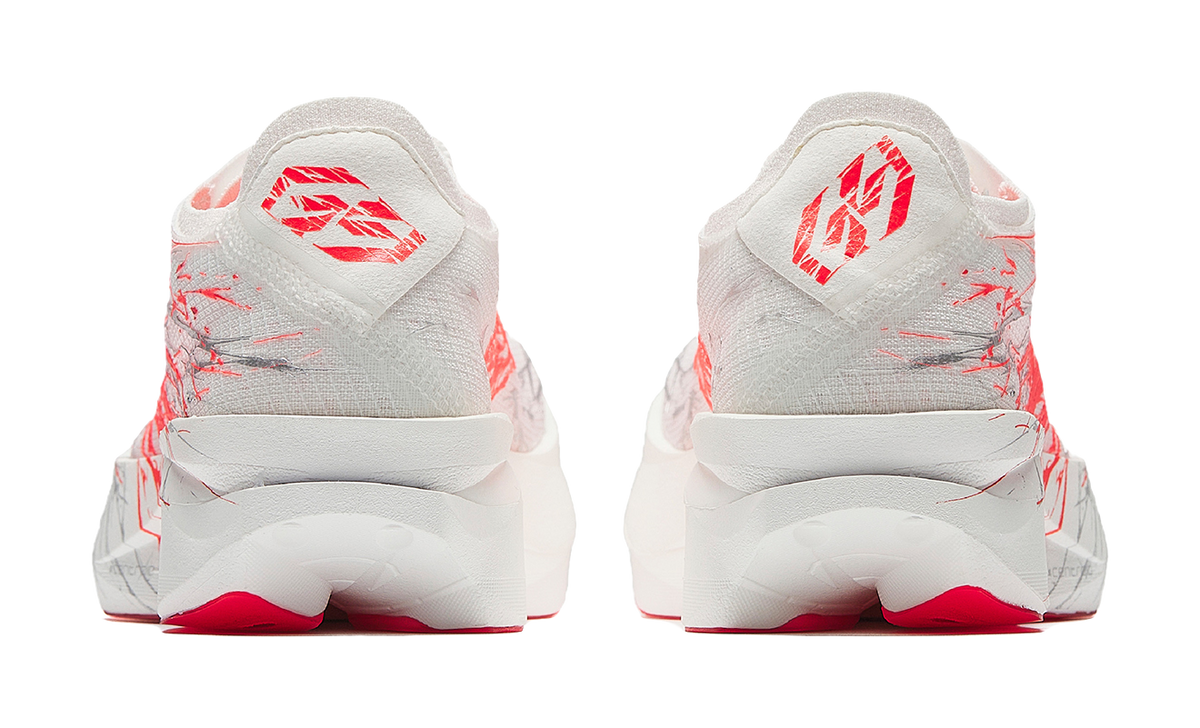 Anta women’s running shoe in white with red heel details and red graphic accents
