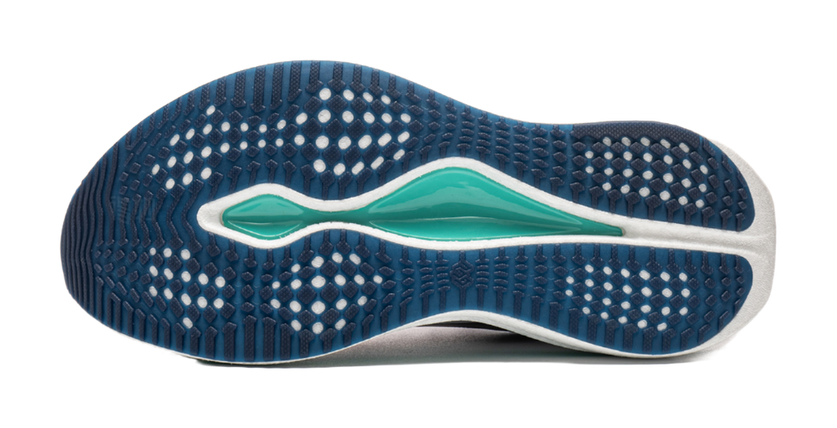 Underside of navy running shoe with teal accent and dotted traction pattern