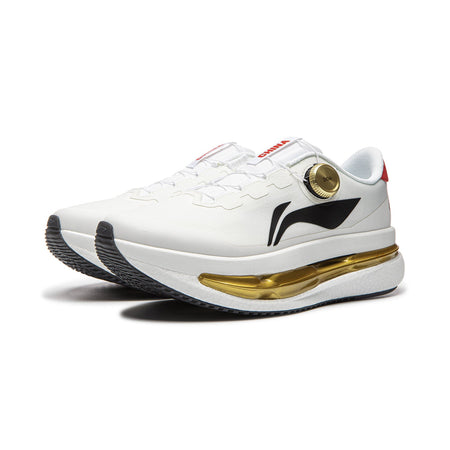 Men's white running shoes with black logo, gold midsole stripe, red heel trim