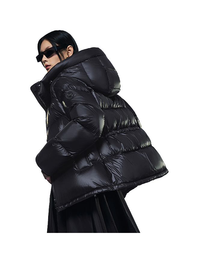Black hooded puffer winter down jacket with large quilted sections and hood up