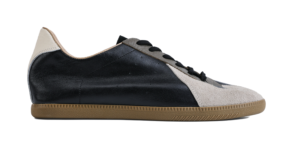 Side view lace-up training shoes, black upper with gray suede panels and gum sole
