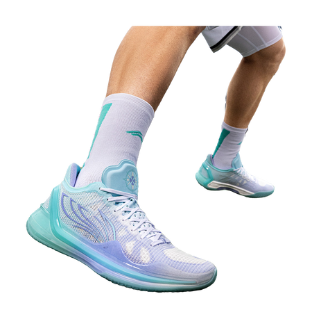 Low-top basketball shoes on feet in light blue and teal with white laces and cushioned sole