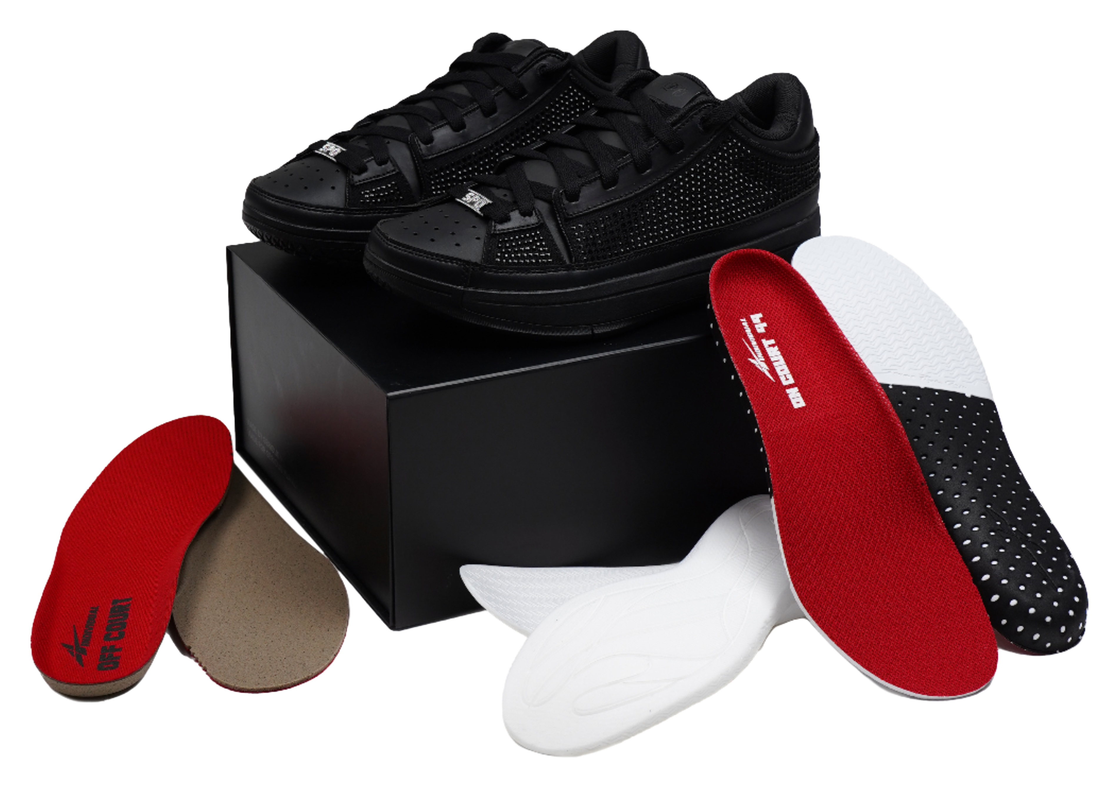 Black basketball shoes with red insole inserts and lace-up uppers, laid out.