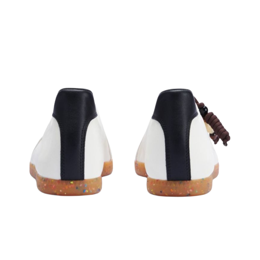 Back view of white low-top training sneakers with dark heel panels and speckled gum sole