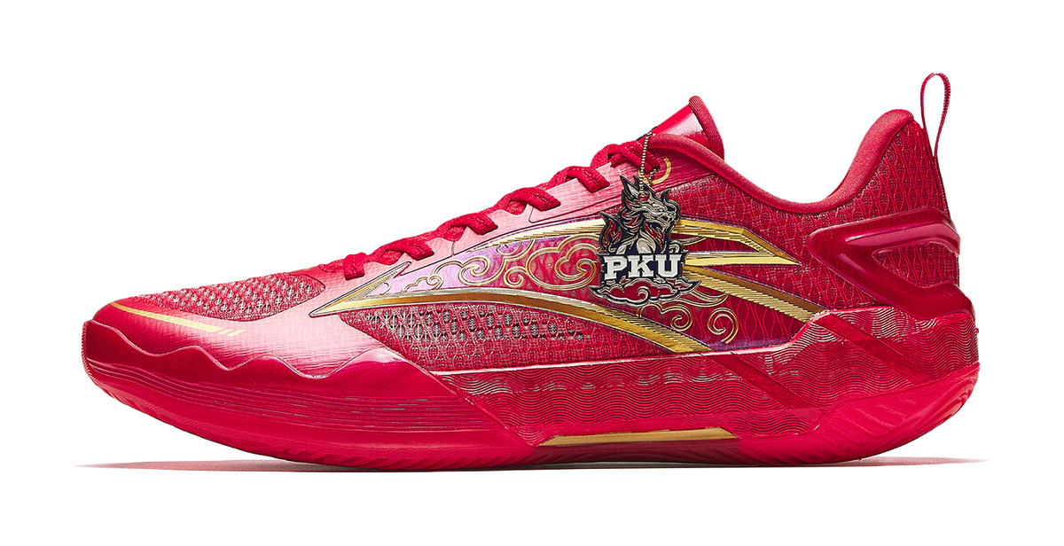Red basketball shoe with gold side graphic, mesh upper, and lace-up front.