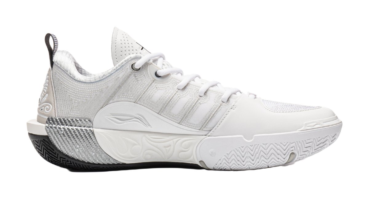 White basketball shoe side view with textured midsole and ankle collar