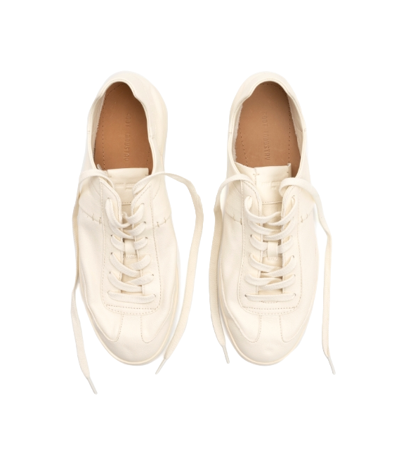 Unisex antique white low-top trainers with white laces, front view